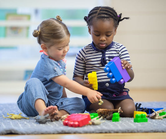 two little girls playing with toys