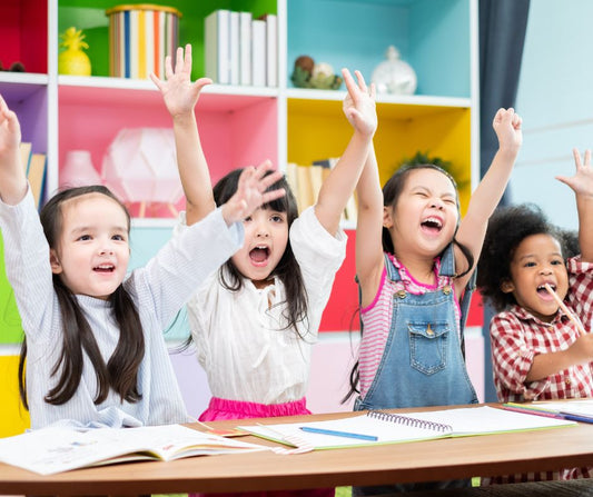 four excited girls in a class