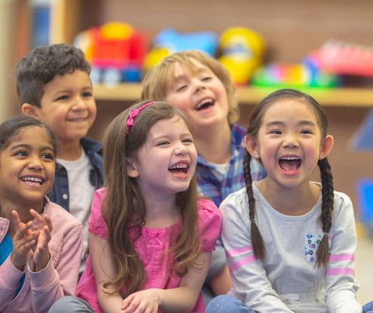 five children excitedly listening to a story